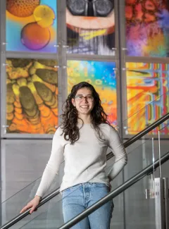 Former Vanderbilt Clark Scholar Yoanna Ivanova stands on a staircase in a university laboratory